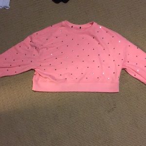 A pink long sleeve crop top with silver dots